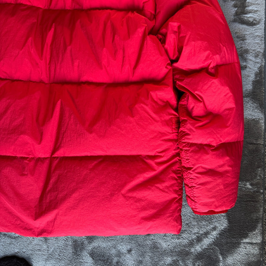 Stone Island red puffer jacket with compass patch, adjustable hood, and multiple pockets.