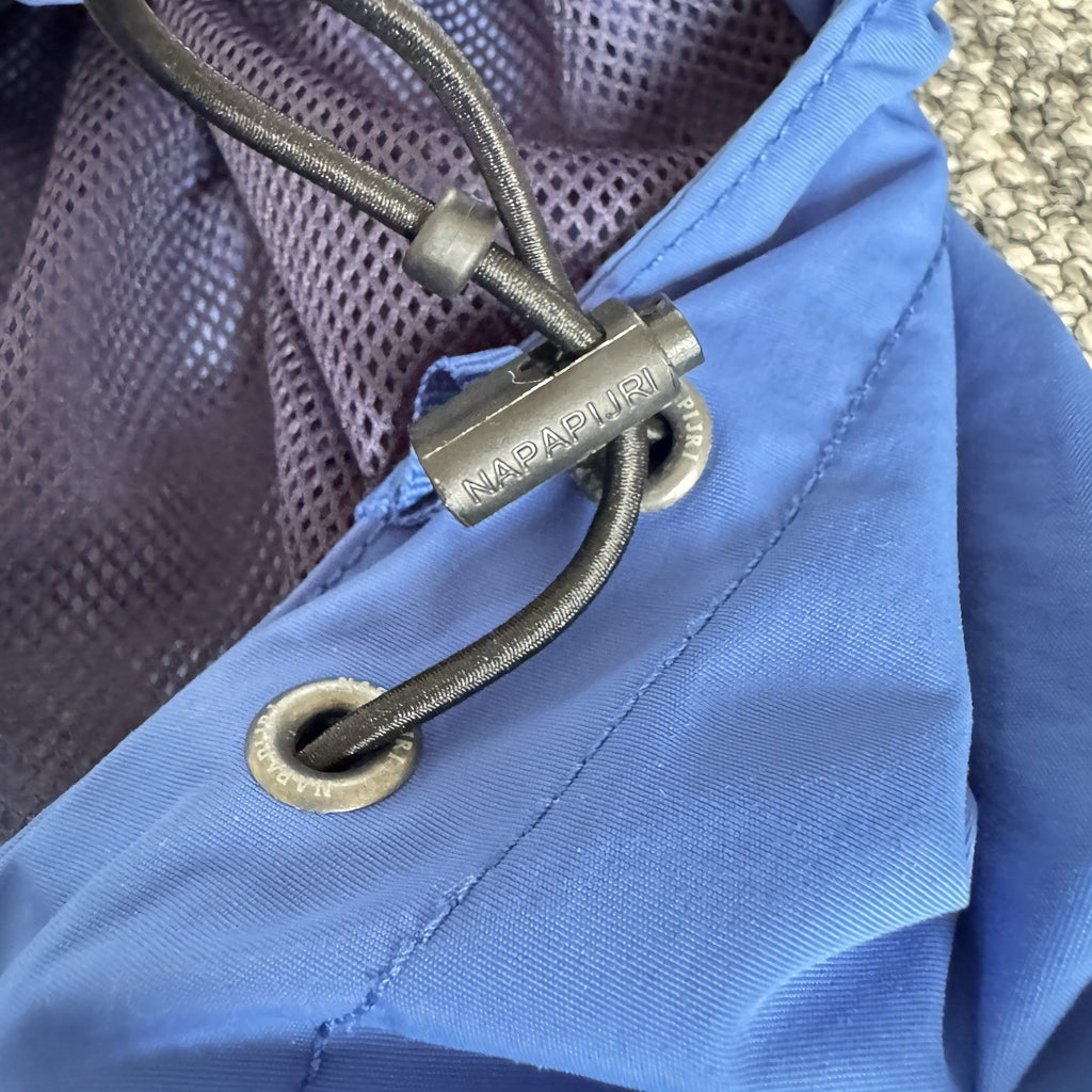 Napapijri blue anorak jacket with logo chest flap and quarter-zip front closure.