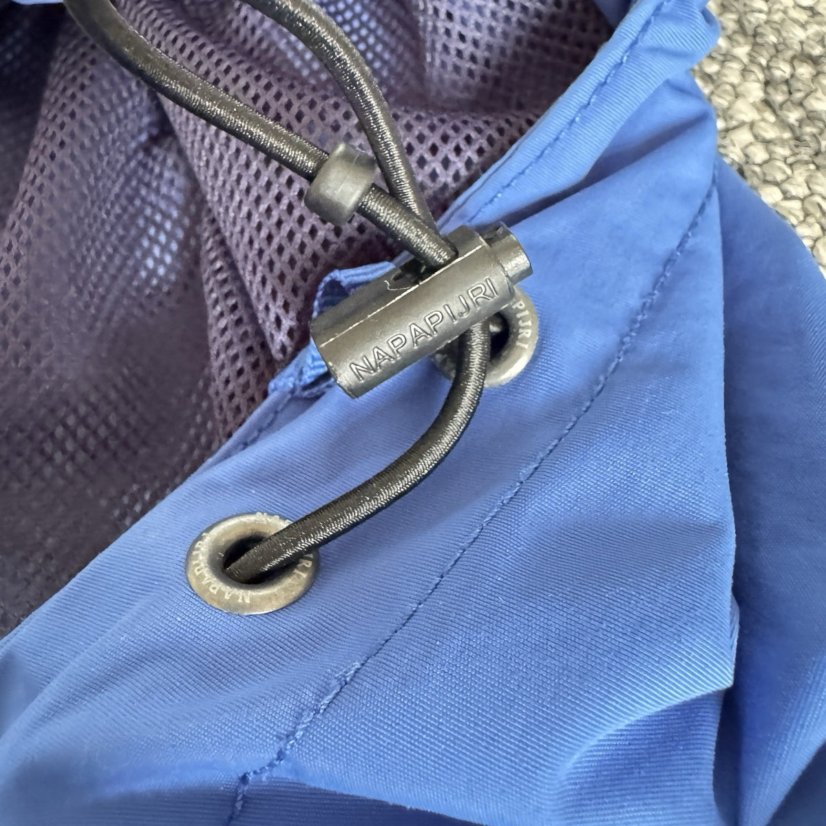 Napapijri blue anorak jacket with logo chest flap and quarter-zip front closure.