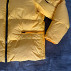 Stone Island yellow down jacket with crinkle reps texture and iconic compass logo.