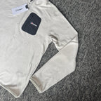 Berghaus off-white half-zip fleece with black logo pocket and stand-up collar.